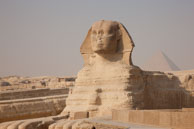 The Sphinx / Famous Sphinx at Giza with one of the Pyramids in the background