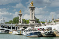 Statues on Pont Alexandre III / Tall columns with golden statues at the end of Pont Alexandre III