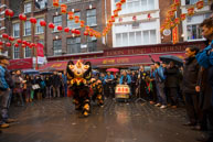 Chinese Lion Dance / Crowds watching a traditional Chinese Dancing Lion on Chinese New Year’s Day in Chinatown