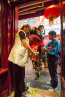 Good luck for the coming year / Jane Li with traditional scroll from the dancing lion on Chinese New Year’s Day
