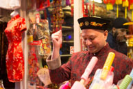 Chinese Shopkeeper / Shopkeeper in Chinatown selling goods for Chinese New Year