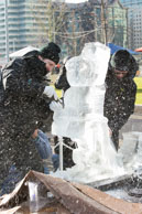 Ice shavings / Polish ice sculptors, Robert Burkat & Michal Mizula, obscured by ice shavings