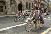 Tandem / Gentleman and lady riding a tandem in the Tweed Run