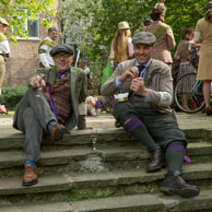 Two Gentlemen / At the end of the Tweed Run, two gentlemen enjoy a glass of champagne and one smokes his pipe