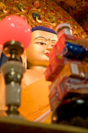 Buddha in Dharamsala / Statue of Buddha in Dharamsala with offerrings in the foreground