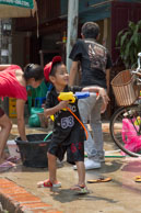 Young boy with water gun / Religious procession for Lao New Year in Luang Prabang and following celebrations