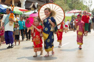 Young girls in procession / Religious procession for Lao New Year in Luang Prabang and following celebrations