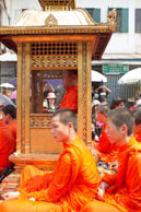 Head monk surrounded by monks / Religious procession for Lao New Year in Luang Prabang and following celebrations