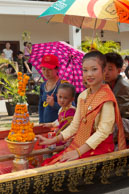 Flower girl in boat / Religious procession for Lao New Year in Luang Prabang and following celebrations