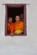 Monks looking out of window / Religious procession for Lao New Year in Luang Prabang and following celebrations