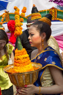Flower girl before entering temple / Religious procession for Lao New Year in Luang Prabang and following celebrations