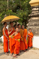 Monks under umbrella / Religious procession for Lao New Year in Luang Prabang and following celebrations