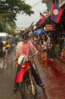 Soaked in front of the cafes / Religious procession for Lao New Year in Luang Prabang and following celebrations