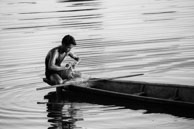 Laos / Traditional fishman on his boat in Laos