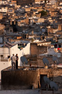 Roof tops in Fes / View across the roof tops in Fes with two man fixing a satellite dish