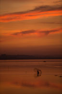 Sunset at Vientiane / Stunning sunset over the river in Vientiane (Laos) with a fisherman casting his net