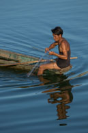 Lao Fisherman / Fisherman sitting on the end of this boat