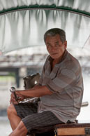Boat man / Traditional Thai boat man steering his boat