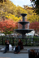 Fountain in New York park / People sitting by a fountain in New York park