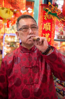 Cigar smoker / Owner of a shop in London's Chinatown smoking his cigar during Chinese New Year 2013 - The Year of the Snake