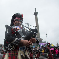 Piper / Piper from the Shree Muktajeevan Pipe Band passing Nelson's Column