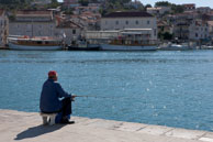 Fisherman on Trogir Quay / Croatia in October 2011