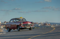 Classic American style Taxi / Classic American car from the 1950s on the hill to the fort which guards the Havana harbour