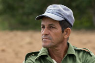 Cuban Farmer / A close up portrait of a Cuban farmer standing beside the fields