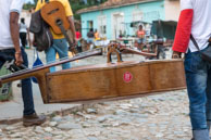 Music Tonight / Cuban musicians carrying a double bass in Trinidad