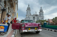Ice Cream and Classic Car / Ice cream seller passes an old American classic car in Parque Cespedes, Santiago de Cuba