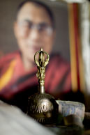 Bell & offerring / Religious bell and offerring in front of a picture of the Dalai Lama