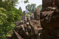 Row of Statues lining a bridge / Temples, their surrounding and people in Seim Reap, Cambodia