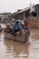 Men on boat / Experiences when travelling through villages in Cambodia