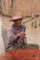 Fisherman paddling / Experiences when travelling through villages in Cambodia