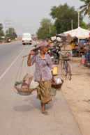 Woman with baskets / Experiences when travelling through villages in Cambodia
