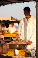 Snail seller in Marrakech / Food seller serving snails to a tourist in Marrakech