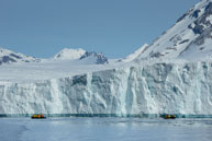 Zodiacs and Glacier / The size of the glacier can be gauged from the zodiacs at Burgerbukta / Brepollen, Svalbard