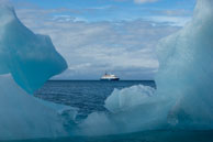 Ship through the Iceberg / Looking through an iceberg at our ship at 14th July Glacier, Svalbard